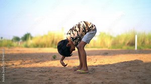 The Dirty hands of a little boy child are digging in the dry mud. Smiling little asian boy have fun digging sand.