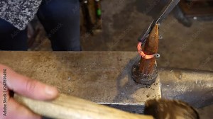 A Female Blacksmith Forging a Handmade Bracelet at the Bick on an Anvil