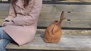 Man steals a woman's bag in the park during the daytime, slow motion