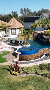 Check out this incredible Insane Pool completed in Central Florida. This backyard features a massive grotto, infinity edge, spa, sun shelf, and a water slide. #insanepools #lucaslagoons #waterslide #backyardgoals | Lucas Lagoons