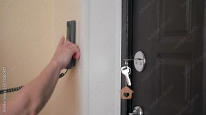 The woman answers the call to the intercom, picks up the phone, opens the door.