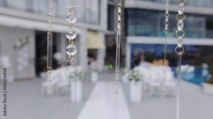beautiful artificial lamp diamonds waved by light wind against blurry wedding hall slow motion close view