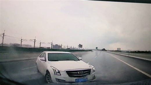 Car skids and spins on rainy highway in Guangdong, China