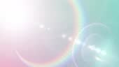 Bright spectrum lens flare on pale blue gradient. Versatile abstract...
