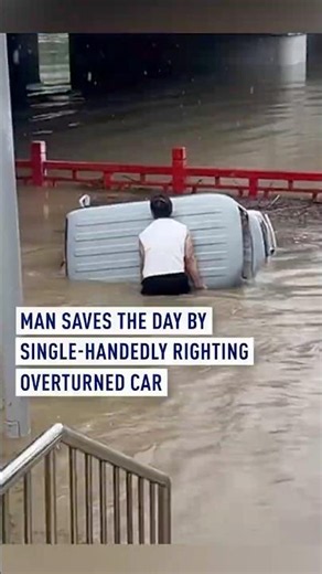 Man saves the day by single-handedly overturning a flooded car