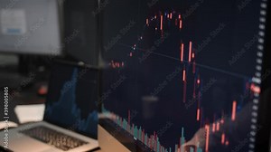 Computer screen with stock market changes, scrolling and analysing numbers. Man and computer display, no face, stock market with green and red market changes