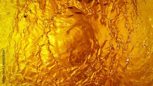 Super Slow Motion Shot of Waving Golden Alcohol Liquid Waves at 1000fps.