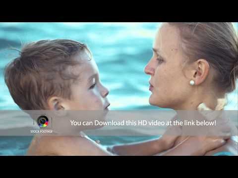 Boy kissing mother while bathing in the sea