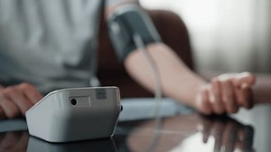 Male Hand Using Automatic Tonometer for Blood Pressure Check