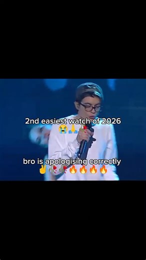 Memes® on Instagram: "This video features a young performer on a talent show stage, delivering a lively vocal and dance performance. Dressed in a white sweatshirt, glasses, and a backward cap, he sings a rendition of Justin Bieber’s "Sorry" alongside a group of backup dancers. The stage is brightly lit with neon geometric patterns and shifting spotlights, creating a high-energy atmosphere. As the performance concludes, the camera cuts to a judge who appears visibly moved, even emotional, as the