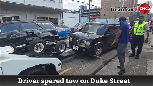 A police officer allowed a driver to keep her vehicle just as a wrecking service was preparing to remove it from a parking spot along Duke Street, Port of Spain. The incident, captured on video by Roger Jacob, shows the wrecker about to extract the vehicle before the officer intervened and released it back to the driver. | CNC3 Television, Trinidad and Tobago