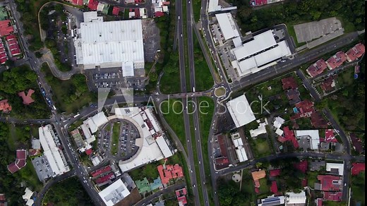 Beautiful cinematic aerial view of a shopping mall in a middle of the city and road