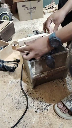 "Hand-Guided Router Carving on Wood Piece"