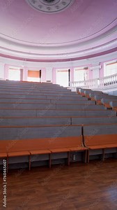 An empty lecture hall in a University. Interior of contemporary lecture theater in university campus Vertical video