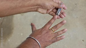 Using a nail clipper to cut the nails. Clipping and polishing nails