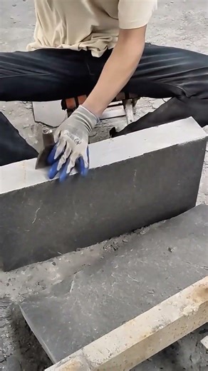 splitting large stone slabs manually using a chisel and hammer for architectural design projects