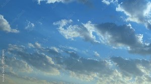 Beautiful cloudscape with large, building clouds and sunrise breaking through cloud mass.