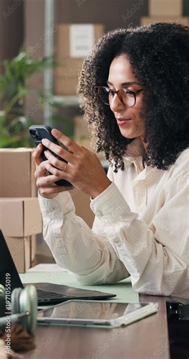 Boxes, phone and typing with woman in logistics plant for management of shipping schedule. Mobile, reading and text message with employee person in supply chain office for delivery or distribution