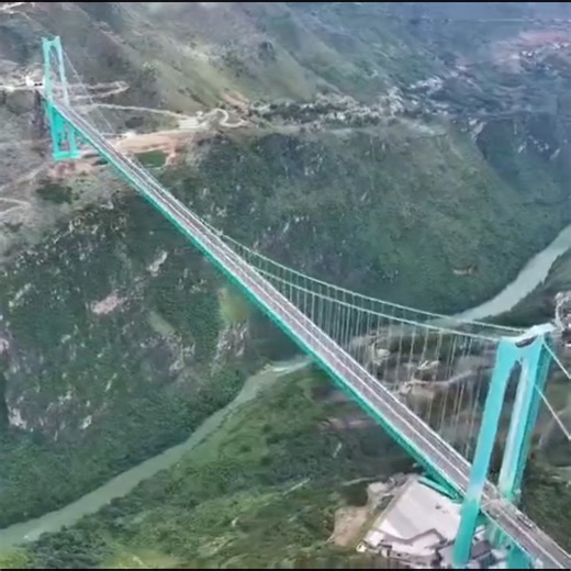 A NEW RECORD GORGE BRIDGE - The Huajiang Canyon Bridge in China has just opened to traffic. It rises 2,051 feet above the Beipan River 👀 Cuts travel down from 2 hours to 2 minutes! It took approximately 3.5 years to build at a cost of $300 million dollars. I'm not sure that's possible in the US these days 🤔 Watch at the end at how run-off from rain can create incredible rainbows! (But drivers will never see them). | Brandon Butcher