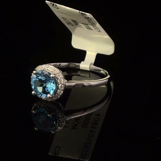 10K White Gold Blue Topaz and 1/10 Cttw Diamond Halo Ring
