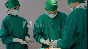 Medical surgery team in the operating room. Assistants and Nurses Performing Surgery.