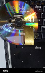 DVD hole around caps lock light diffraction spectrum colours disc audio video with padlock Stock Photo - Alamy