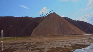 Mining industry close up. Telestacker handles the ore for potash waste heaps, extraction of salt and potash fertilizers in a quarry and processing of ore