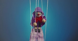 Marionette Clown Hanging on Strings and Dancing