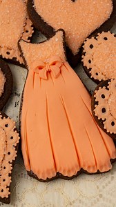 64K views · 228 reactions | I used modeling chocolate and royal icing to decorate these pretty peach dress cookies. Modeling chocolate is similar to fondant but tastes a lot better, in my opinion. The instructions and recipes are in the Cookie Art Club! #decoratedcookies #royalicingcookies #sugarcookies #modelingchocolate | SweetAmbs | Facebook