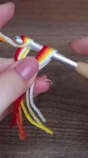 the process of making a knot using wool thread in making a craft#shorts