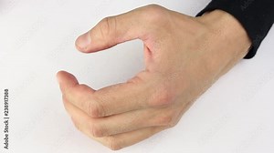 man hits the table with his fist, squeezes it hard, slowly unclenched, closeup