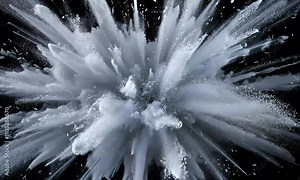 A dramatic explosion of white powder against a black background, creating a striking visual effect that emphasizes movement and energy.
