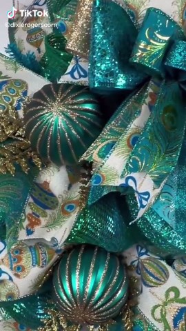 Transform your home with the rich, regal beauty of this Peacock-Themed Christmas Wreath — a true showstopper for your front door, wall, or entryway. Handcrafted on a brilliant deco mesh base, this elegant wreath sparkles with shimmering turquoise, emerald, gold, and peacock-feather patterned ribbons layered into full, fluffy bows. This wreath is perfect for year-round elegance and eye-catching style. This full, fluffy wreath features a 6” glittered gemstone that brings a bold pop of color to you