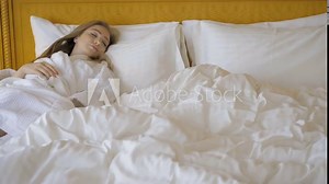 Beautiful young girl sleeping in hotel bed