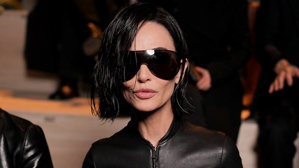 Demi Moore walks the red carpet in a gold dress at the 2025 Golden Globes