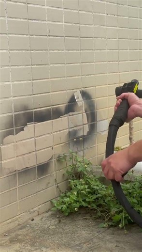 How do you remove graffiti from outdoor tiles without damaging the surface?