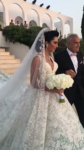 Here comes the bride ..Check out her incredible ceremony setup and distinguished dress !