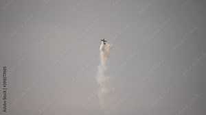 A small plane during an aerobatic simulation: plane engine failure, white smoke coming out from the engine as the plane crashes