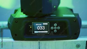 Professional technical light spotlight is spinning, close-up. Light board with technical parameters of the stage lighting installation, beam.