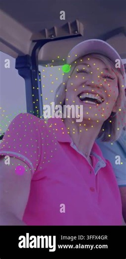 Vertical video: Woman smiling, taking selfie with man in golf cart, confetti drifting over faces. Couple, outdoor, sunny, course, selfportrait, laughter, vertical video