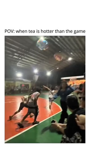 thememers🔥 on Instagram: "When the sideline drama is more intense than the game! 🏀😂 Two girls get into a playful hair-pulling skirmish at a local basketball court, sending the crowd into a frenzy of laughter and cheers. The video takes place at night inside an indoor basketball gymnasium with green flooring and red painted keys. In the foreground, two young women appear to be playfully fighting or "horseplaying" near the sidelines. One girl, wearing a long-sleeved blue top, grabs the hair of