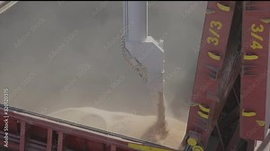 loading wheat into a tanker, a ship with wheat. Loading grain into a cargo ship