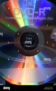 DVD hole around caps lock light diffraction spectrum colours disc audio video Stock Photo - Alamy