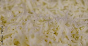 grated yellow semi-hard cheese with holes, fresh cheese from milk grated with pieces for cooking