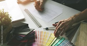 designer doing paint color selection from swatch for home interior design project