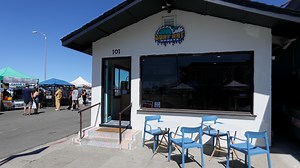 See freshly fried doughnuts at Surf Rat Donuts across from the beach.