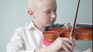 A child learns to play the violin in a music school.