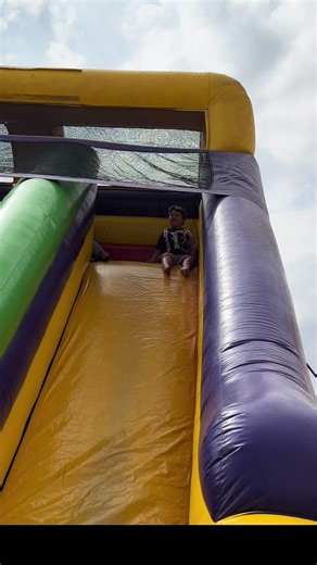 This is my son Zeus. He’s 5 years old and has level 3 autism. What looks like a simple inflatable slide to most kids can feel like a huge challenge for him. While the other kids run up and down without thinking… Zeus is trying to understand it in his own way. Stimming, feeling the excitement, and figuring it out step by step. Sometimes other kids don’t know how to interact with him. They just keep playing. But then… Zeus takes a leap of faith. And when he finally slides down, it may look like so