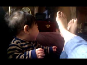 Toddler who laughs at feet movement
