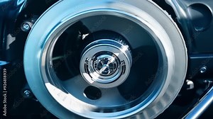 Shiny metal supercharger spins fast, boosting car engine power. Steel, chrome machine adds tech to auto mechanics for more speed